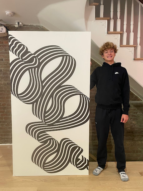 Nick Cornell standing beside a large black and white abstract artwork